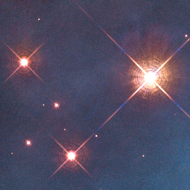 Three bright stars (point sources) in the Pillars of Creation image showing diffraction effects.